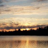 A picture of a sunset over a lake